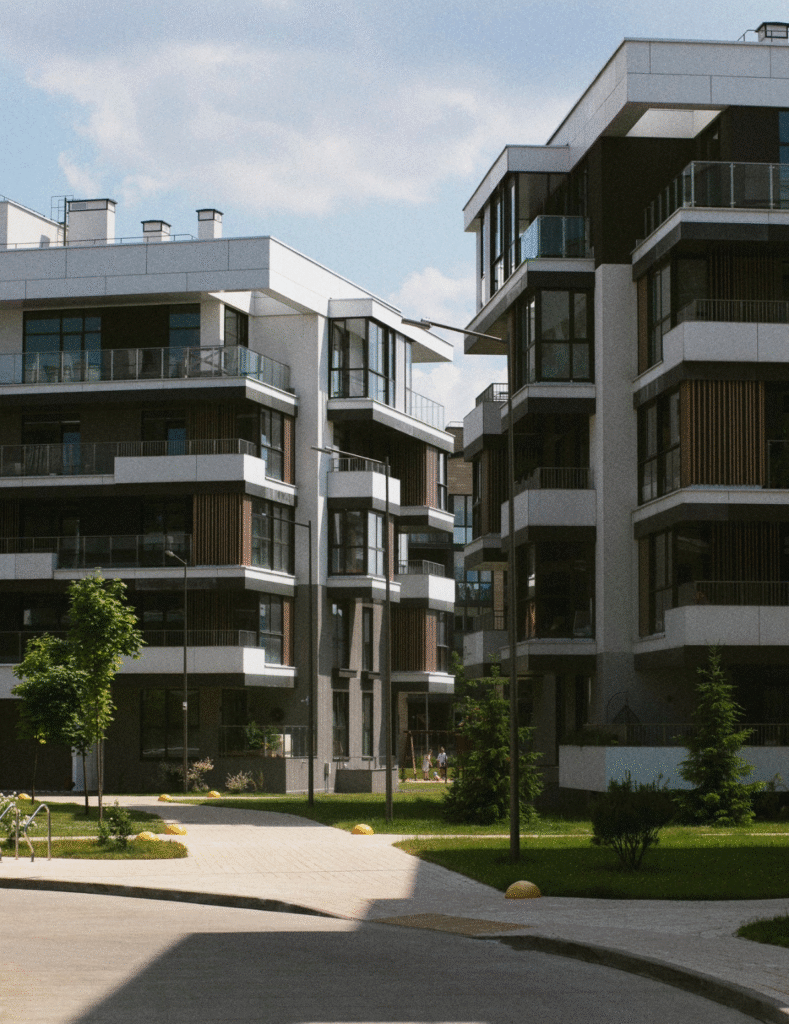 Modern apartment buildings rise in a residential area, showcasing contemporary architecture and urban living.